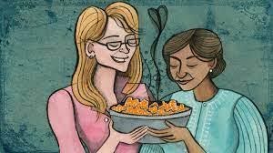 two woman in front of a plate full of food